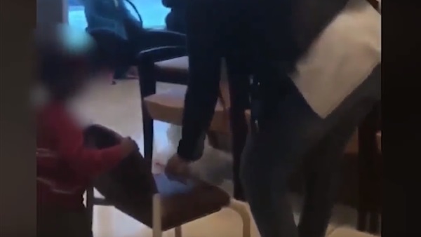 سيدة تجر طفلها من